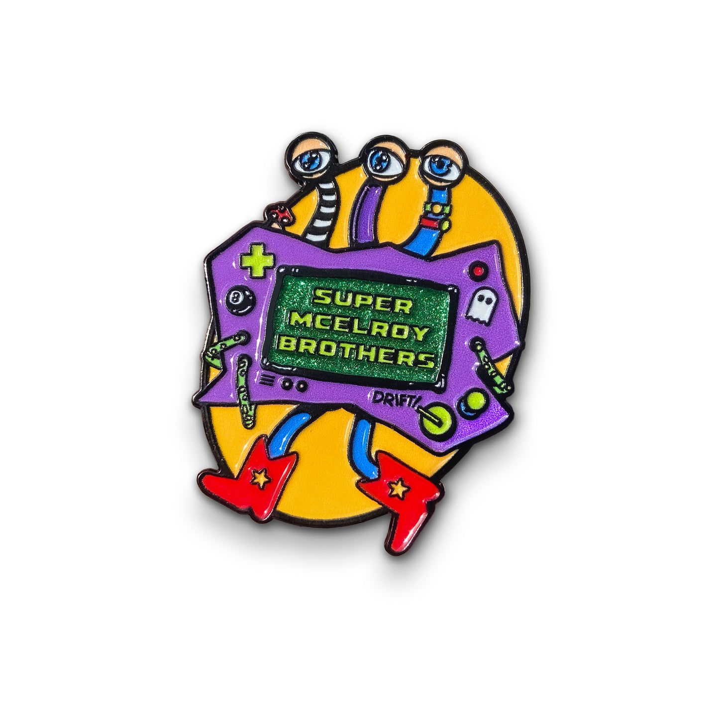 An enamel pin depicting the Super McElroy Brothers controller creature. The creature has a purple body with a center screen that says, “Super McElroy Brothers”. It has three eye stalks, each representing a McElroy brother and is wearing red cowboy boots with yellow stars on them. Behind it is a bright yellow oval.