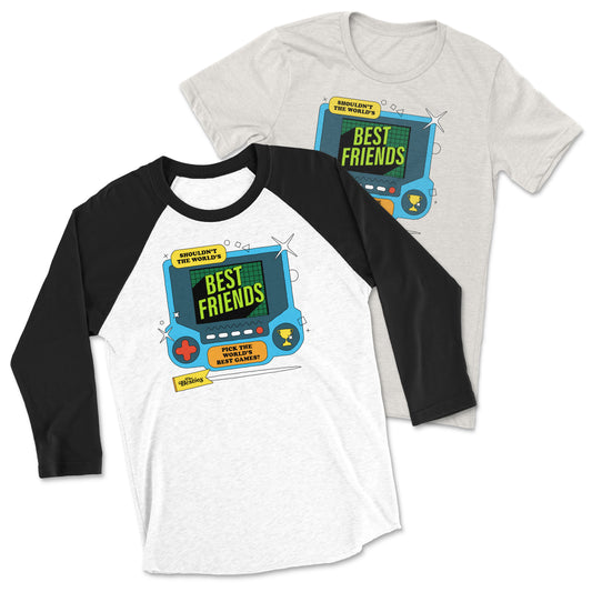 Two shirts with the same design. A t-shirt with a graphic of a blue game system. It says, “Shouldn’t the world’s best friends pick the world’s best games?” There are circles, squares, and triangles around the game system. Below the game system is a yellow banner that says, “The Besties”. The same design is shown on the front of a white raglan tee with black 3/4 length sleeves and a black collar. 