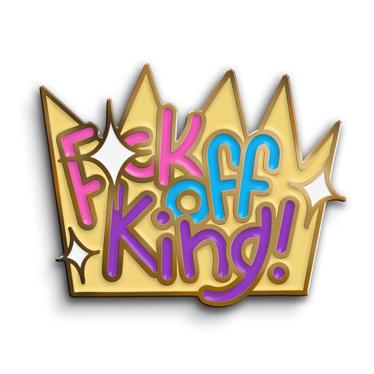 An enamel pin of a yellow crown with white sparkle shapes. In pink, blue, and purple bubble letters it says, “Fuck off King!”