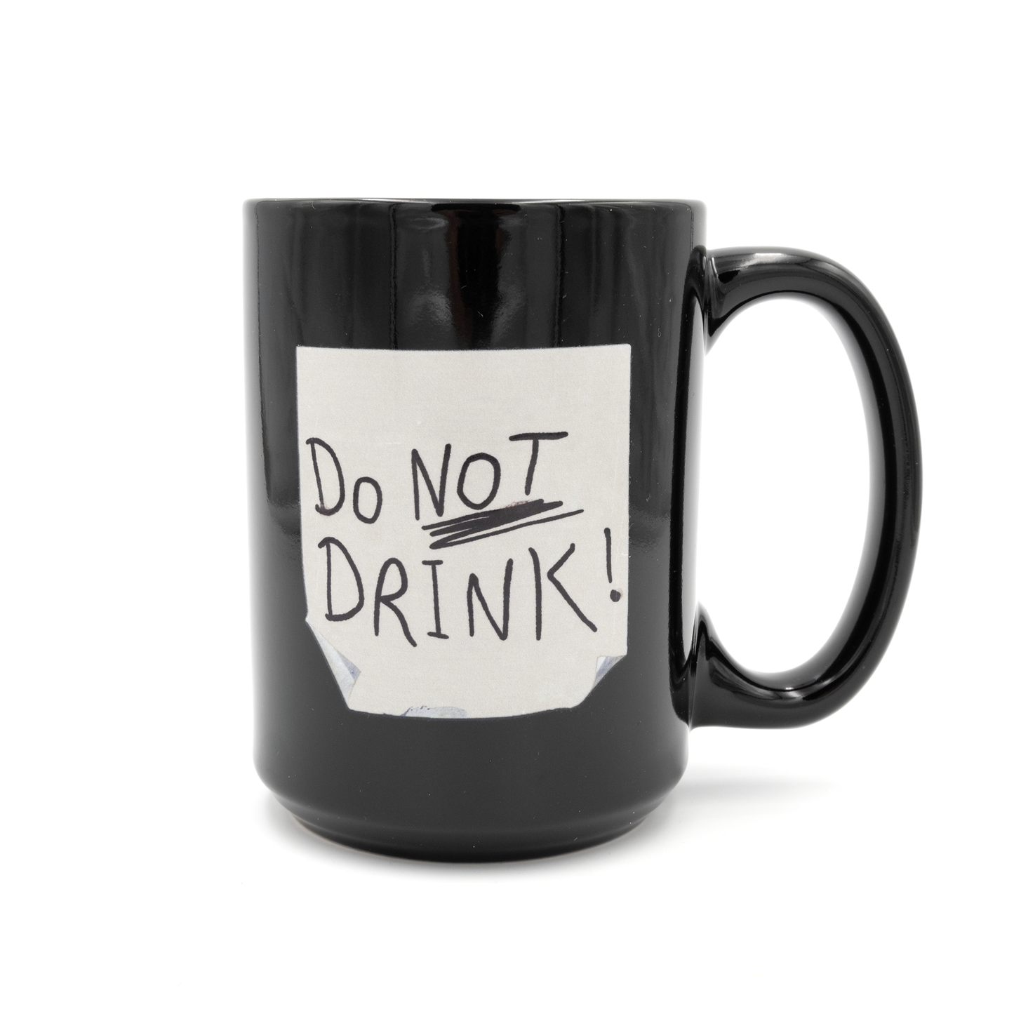 Black mug with DO NOT DRINK written on what looks to be a post it note printed on the front of the mug.