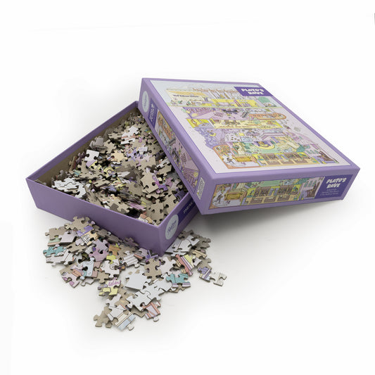 Purple puzzle box that says Plato's Rave and has puzzle pieces within and spilling out of the box.