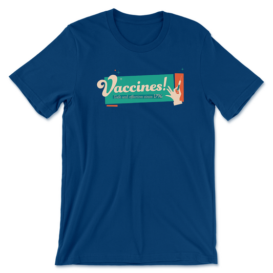 A cool blue tee-shirt that says "Vaccines!" in cream lettering. Below that it says, "Safe and effective since 1796". There is a hand holding a small syringe to the right. Behind the words and hand is a large teal rectangle with an orange one next to it.