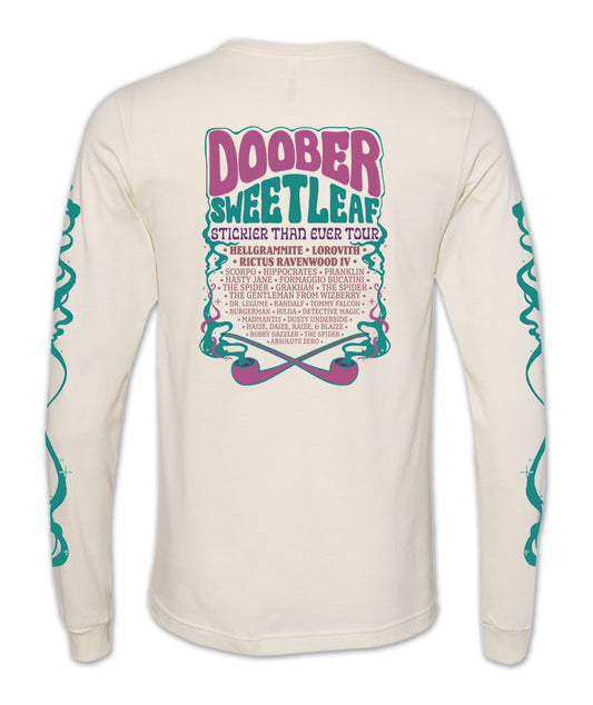 A cream colored long sleeve shirt with tour-style graphics. The back lists the name of the tour and the performers inside an illustration of two crossed purple pipes with teal smoke wafting out of them. At the top of the list it says, “Doober Sweetleaf Sticker Than Ever Tour” with the additional performers listed below. The teal smoke graphic is repeated on the sleeves of the shirt.