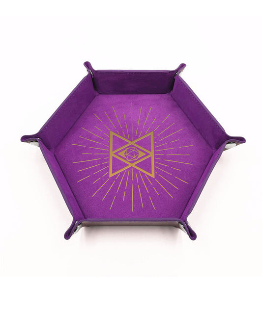 A photo of a purple dice tray with foldable snap sides. It features a gold foil design of an hourglass shape with a d20 in the middle.