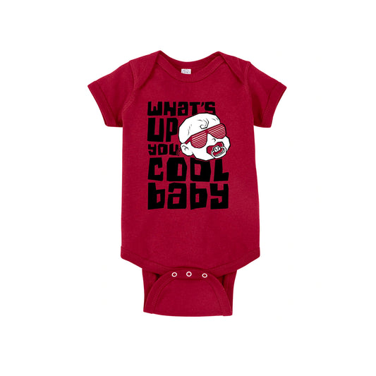 A red baby onesie that says, "What's up you cool baby" in block font. There's a white baby head with a red pacifier and red shutter shades.