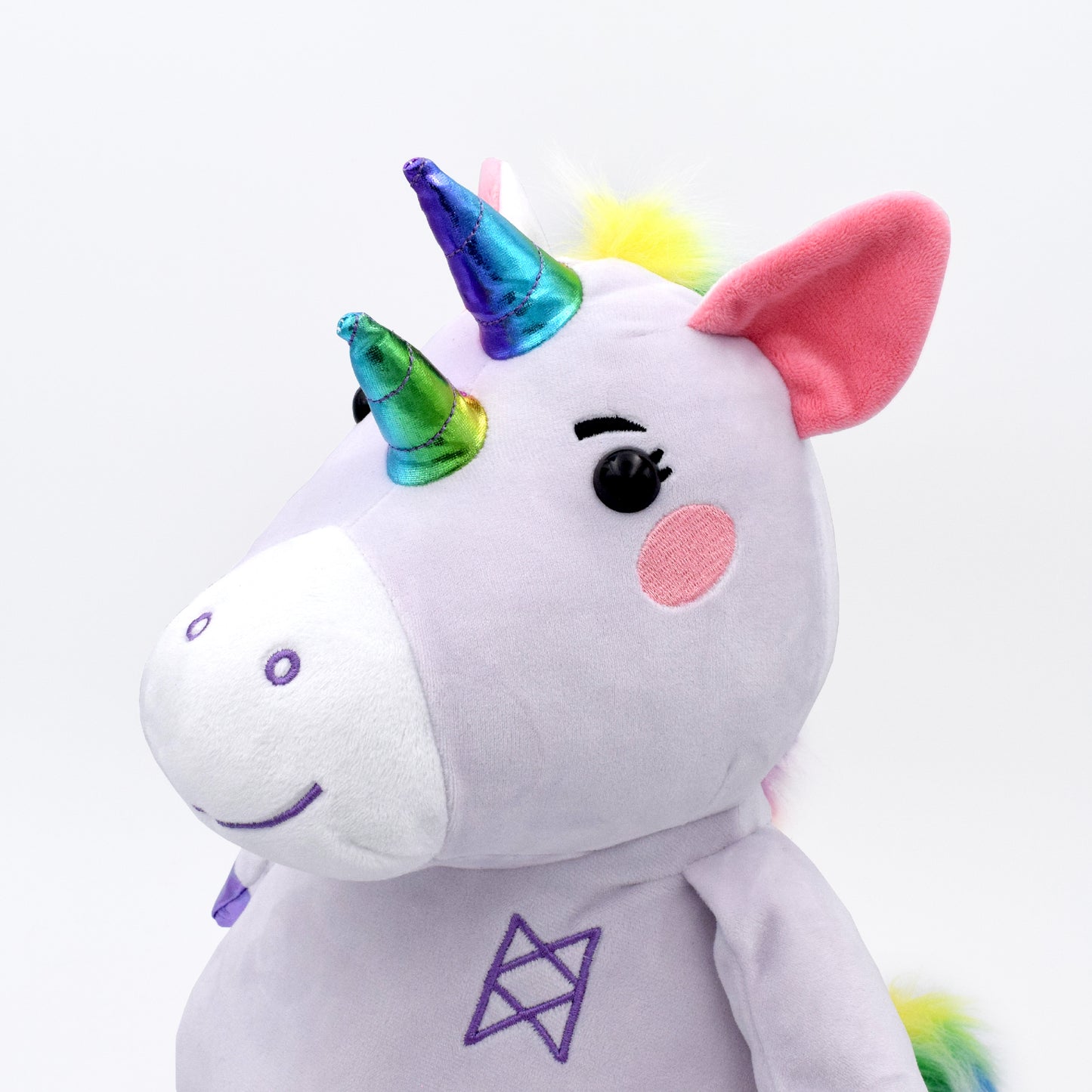 A stuffed Garyl plushie with a purple body, pink cheeks, two shiny rainbow horns, shiny purple hooves, and a bright rainbow faux fur mane and tail. 