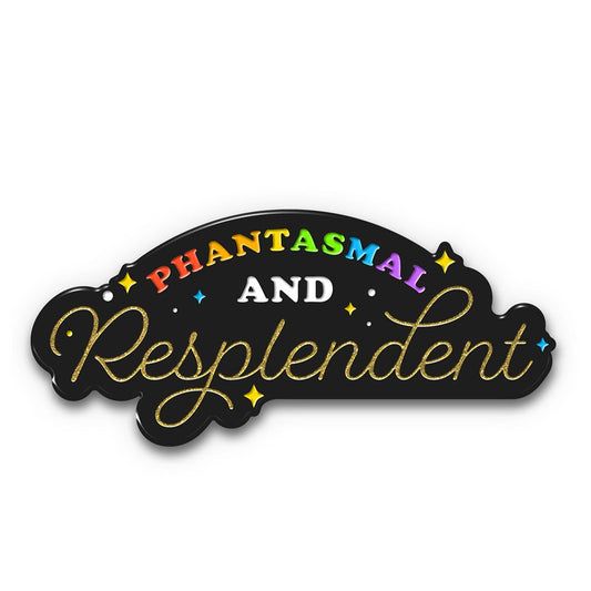 An enamel pin that says, "Phantasmal and Resplendent". The "phantasmal" is in rainbow and "resplendent" is in gold. The background of the pin is black with blue and yellow sparkles.
