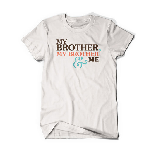 A cream colored shirt that says, "My Brother, My Brother & Me". The second "My Brother" is peach and the "&" is teal.