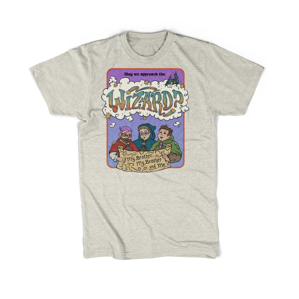 Image of the July McElroy merch item. It is a cream colored tee-shirt. On the front is an illustration of the McElroy brothers in colorful cloaks holding a scroll between them with a red border and purple gradient background. The scroll says, “My Brother, My Brother and Me.” Above them, the shirt says, “May we approach the Wizard?” “Wizard” is written in colorful, funky text inside a thought cloud above the brothers’ heads. Around the shirt are sparkles and yellow bursts of color.