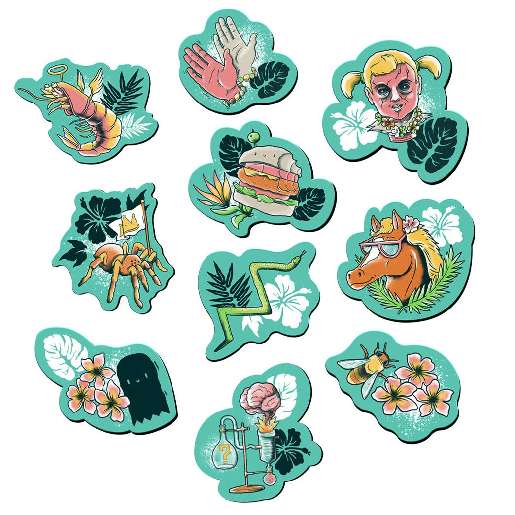 Image of 10 magnets. They all have a green background with a hibiscus or leaf. Top row left to right: a shrimp with a golden halo and wings; a pnk and grey waving hand wearing a colorful bracelet; a haunted doll with blond hair. Center left to right: a tarantula holding a flag; a burger with a bite taken out of it; a zig-zag snake; a horse wearing sunglasses. Bottom row left to right: a black ghost with pink and yellow flowers; a brain bursting out of a vial; a bee with pink and yellow flowers.