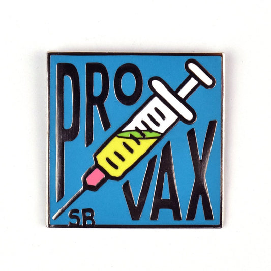 A light blue enamel pin. In the center is a white syringe filles halfway with a yellow and green liquid. Above it says "Pro" and below it says "Vax". In the bottom left corner is an "S" and a "B".