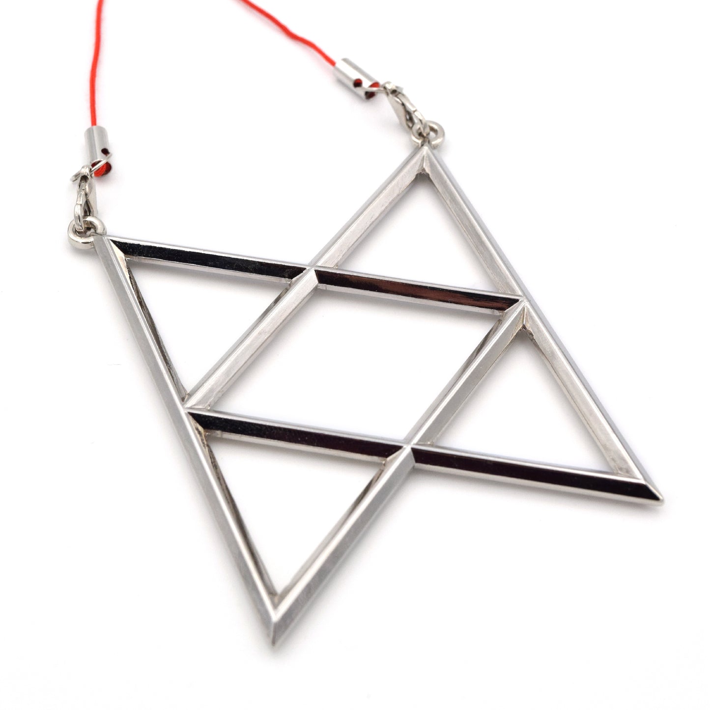 A silver metal ornament is the shape of the BoB symbol. The hanger is a red thread that strings across the top two points.