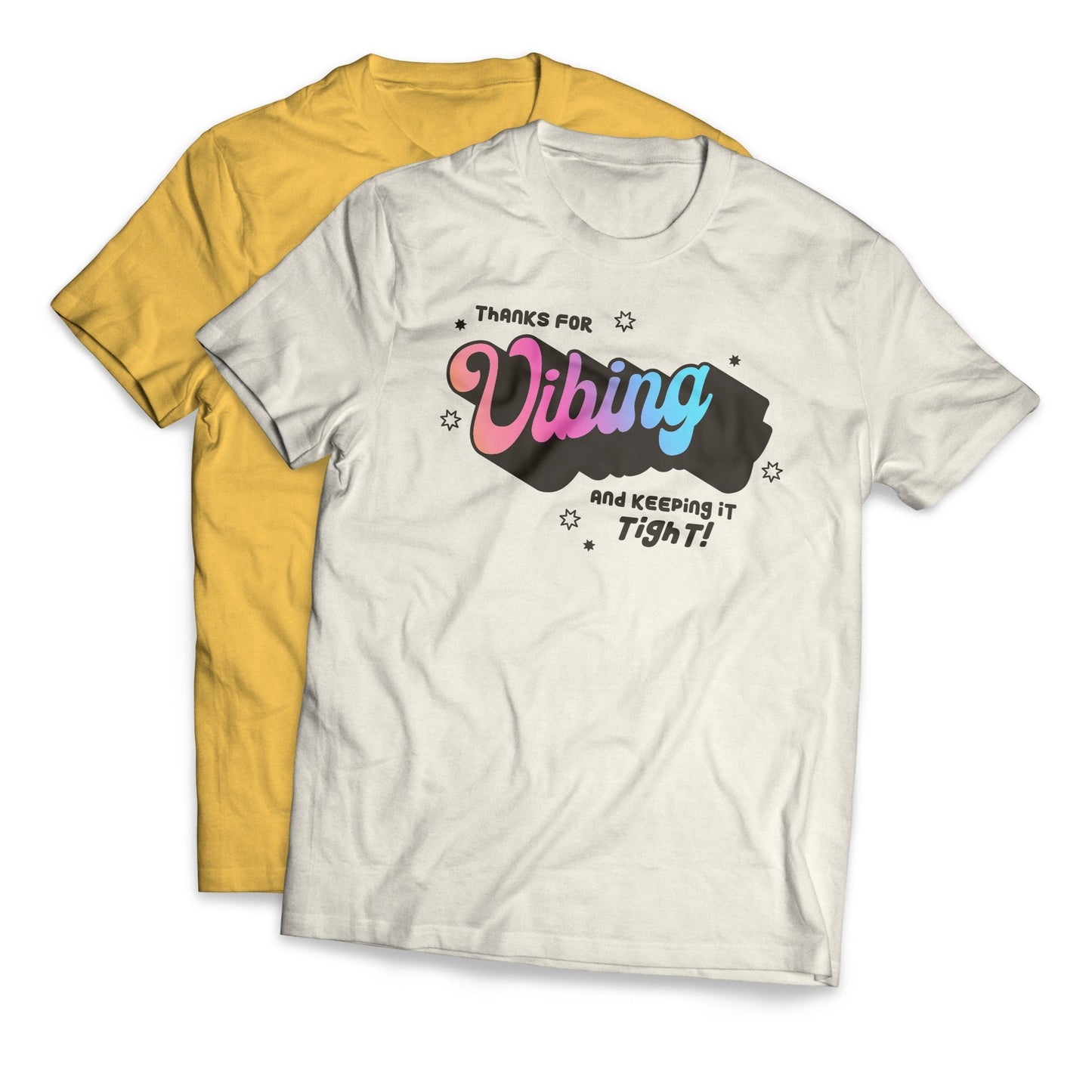 Two shirts that say “Thanks for vibing and keeping it tight!” The “vibing” is a pastel gradient in a larger, retro handwritten font. The shirt in the back is a gold color and the shirt in the front is a cream color.